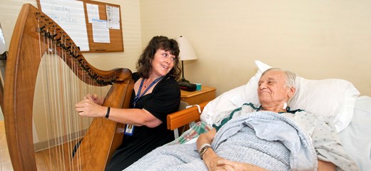 Harpist plays peaceful music for a patient.
